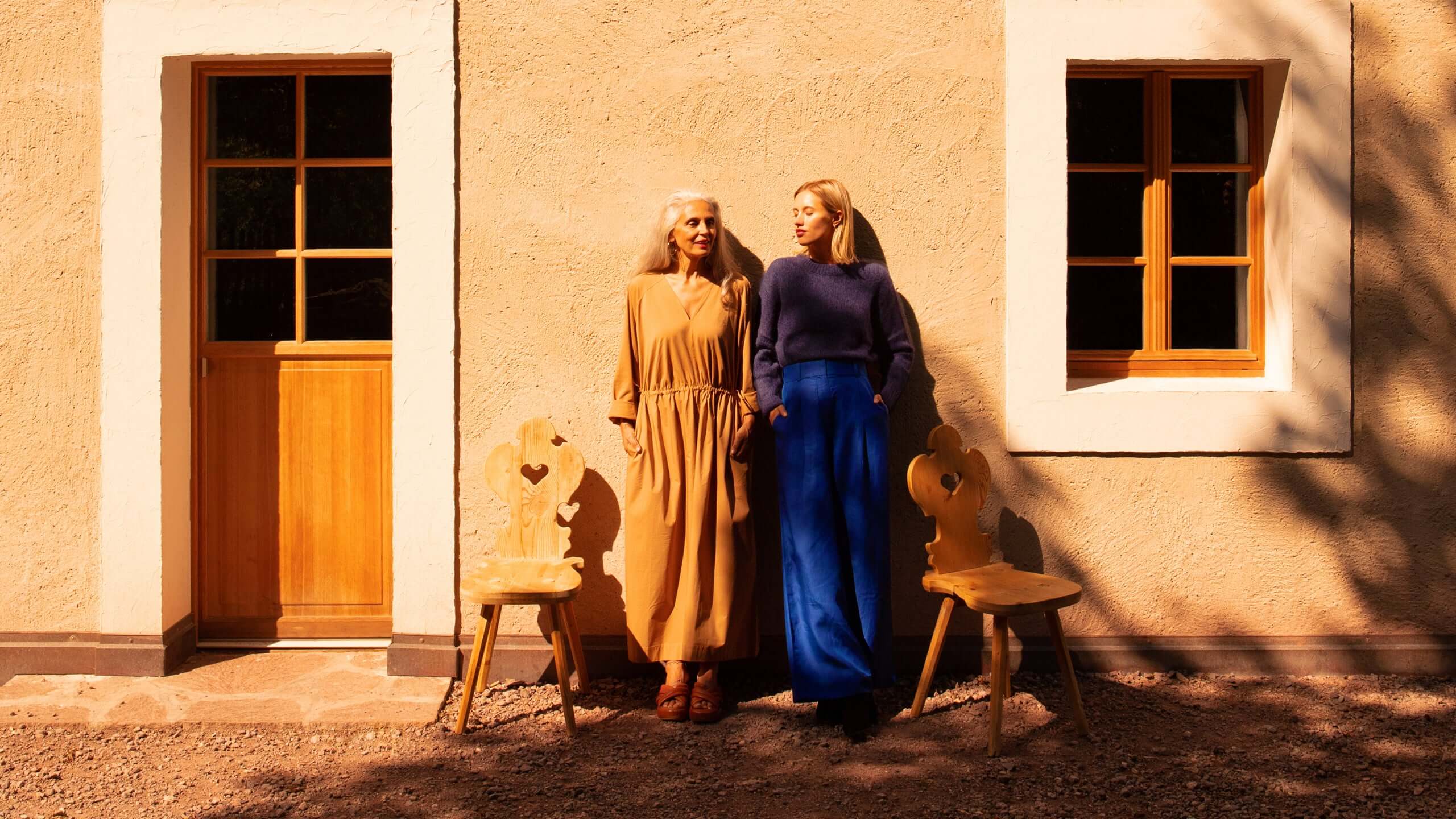mother and daughter in front of the house