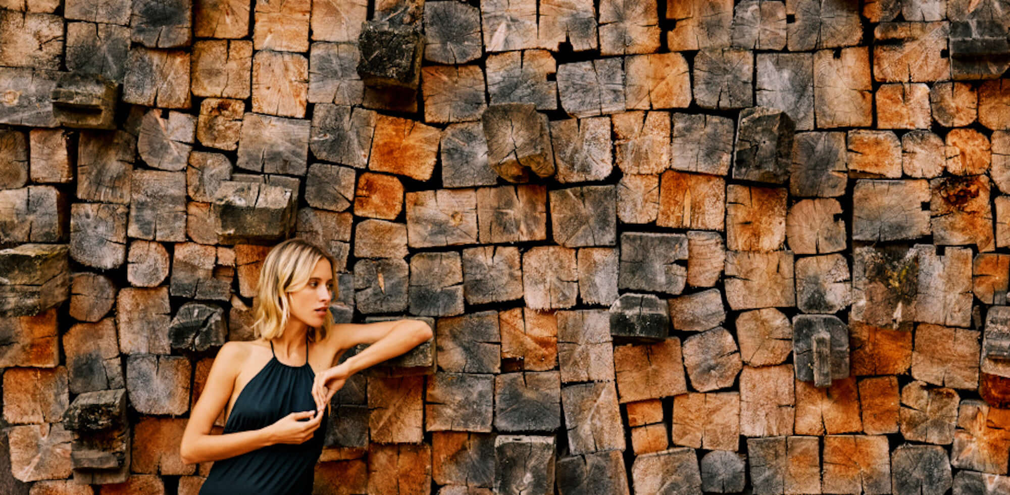 beautiful woman next to wooden wall
