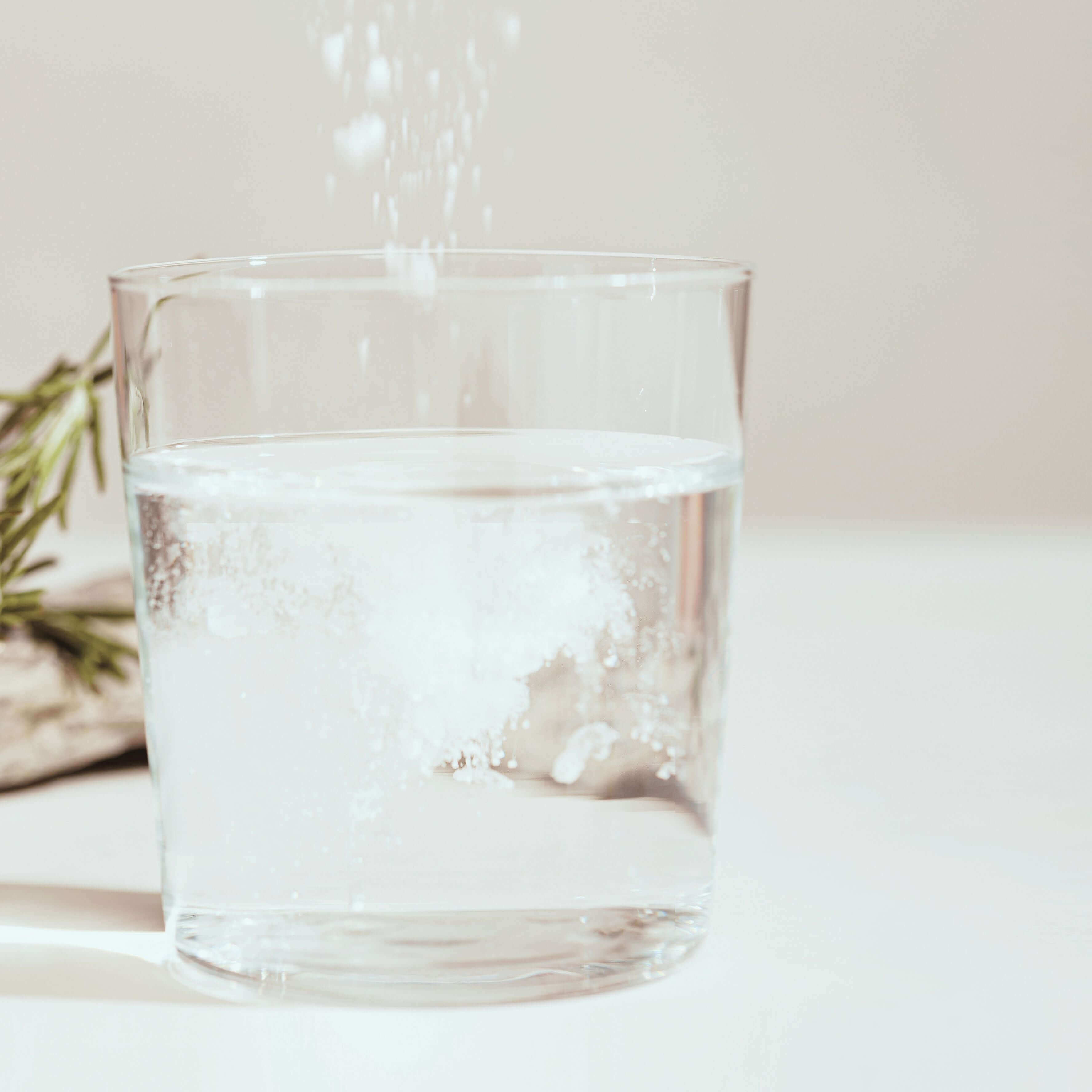 a glass filled with water featuring how the powder is going to dissolve